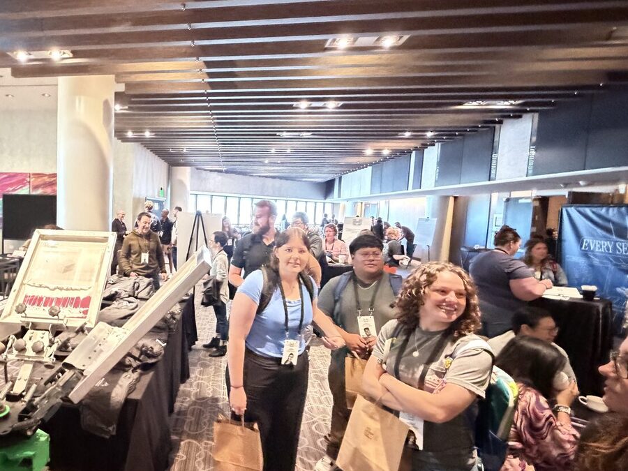 Event crowd carrying custom printed totes as favors