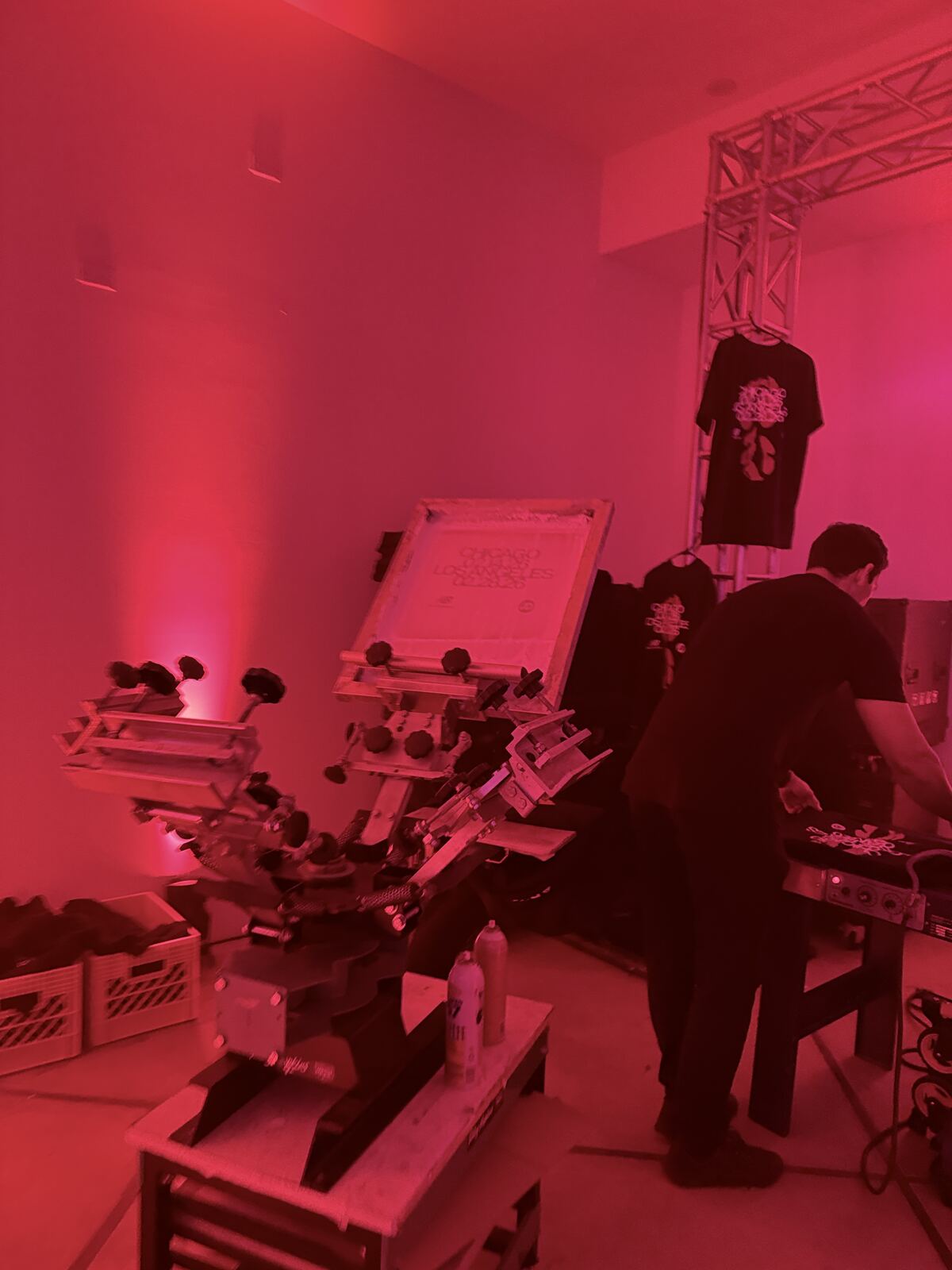 Professional event booth interior with decorated apparel products and samples displayed on walls
